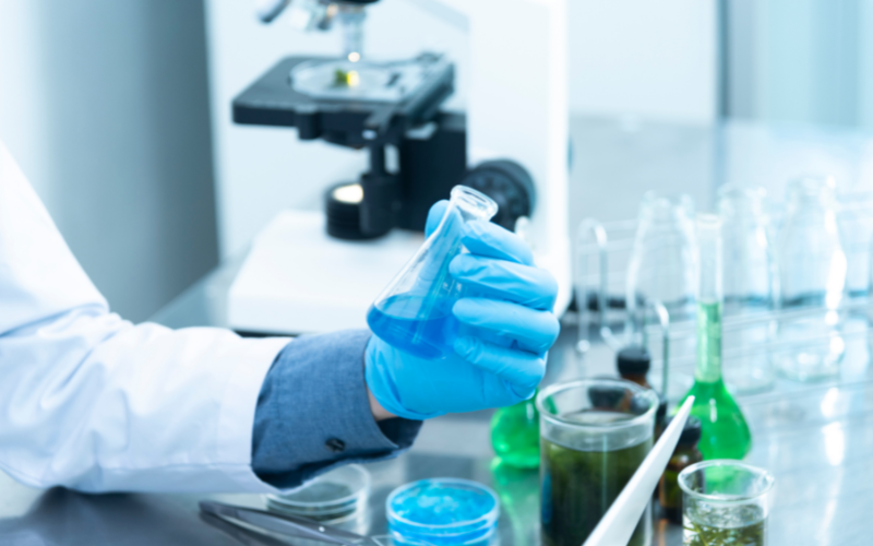 person holding laboratory flask 800 x 500